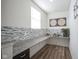 Bright pantry features ample counter space, stylish backsplash, and wood-look flooring at 15365 Todd S Ln, Fishers, IN 46037