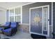 Cozy front porch with seating, a decorative door hanging, and gray siding at 15365 Todd S Ln, Fishers, IN 46037