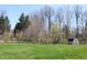 Expansive green backyard with mature trees and an outbuilding shed at 1631 Wilford Ln, Indianapolis, IN 46229