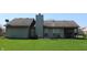 The backyard features a large grassy area with a covered porch perfect for outdoor living at 1631 Wilford Ln, Indianapolis, IN 46229