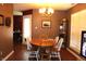 Dining area featuring wood floors, neutral colors, and a modern light fixture at 1631 Wilford Ln, Indianapolis, IN 46229