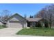 Charming single-story home featuring a well-maintained front yard, attached garage, and brick accents at 1631 Wilford Ln, Indianapolis, IN 46229