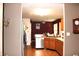 Open kitchen with wood cabinets, stainless steel appliances and hardwood floors at 1631 Wilford Ln, Indianapolis, IN 46229