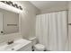 Bathroom with a white vanity, framed mirror, toilet, and a shower with curtain at 1632 Queensbridge Sq # 7, Indianapolis, IN 46219