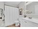 Bright bathroom with white vanity, toilet, framed Koala photo, and shower with white curtain at 1632 Queensbridge Sq # 7, Indianapolis, IN 46219