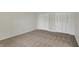 Bedroom with neutral walls and carpet, as well as ample closet space with bi-fold doors at 1632 Queensbridge Sq # 7, Indianapolis, IN 46219