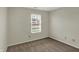This carpeted bedroom features a window with blinds for natural light at 1632 Queensbridge Sq # 7, Indianapolis, IN 46219
