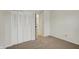 Bedroom featuring carpet flooring, a closet with bi-fold doors, and neutral colored walls at 1632 Queensbridge Sq # 7, Indianapolis, IN 46219