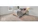 Cozy bedroom featuring neutral tones, carpet, and natural light from the window at 1632 Queensbridge Sq # 7, Indianapolis, IN 46219