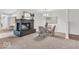 Open-concept dining area with a brick fireplace, modern lighting, and a view into the kitchen at 1632 Queensbridge Sq # 7, Indianapolis, IN 46219
