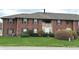 Exterior view of a brick apartment building with manicured landscaping at 1632 Queensbridge Sq # 7, Indianapolis, IN 46219