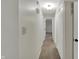 Hallway features neutral paint, carpet flooring, and white closet doors at 1632 Queensbridge Sq # 7, Indianapolis, IN 46219