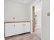 Hallway features white cabinets and vinyl plank flooring that lead to another room at 1632 Queensbridge Sq # 7, Indianapolis, IN 46219