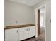Hallway with built-in cabinets and view into another carpeted room at 1632 Queensbridge Sq # 7, Indianapolis, IN 46219