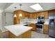 Well-lit kitchen features stainless steel appliances, light countertops, and wood cabinets at 1632 Queensbridge Sq # 7, Indianapolis, IN 46219