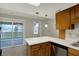 Kitchen with stainless steel dishwasher and slider access to a balcony at 1632 Queensbridge Sq # 7, Indianapolis, IN 46219