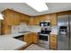 Modern kitchen with stainless steel appliances and ample counter space at 1632 Queensbridge Sq # 7, Indianapolis, IN 46219