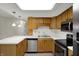 Updated kitchen featuring stainless appliances, wood cabinets and bright countertop at 1632 Queensbridge Sq # 7, Indianapolis, IN 46219