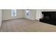 Bright living room with a fireplace and carpeted floors at 1632 Queensbridge Sq # 7, Indianapolis, IN 46219