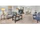 Spacious living room showcasing a cozy fireplace, neutral tones, and an adjacent dining area at 1632 Queensbridge Sq # 7, Indianapolis, IN 46219