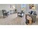 Well-lit living room featuring neutral decor, comfortable seating, and a welcoming ambiance at 1632 Queensbridge Sq # 7, Indianapolis, IN 46219
