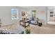 Inviting living room with large windows, a sofa, and stylish decor, offering a bright and airy feel at 1632 Queensbridge Sq # 7, Indianapolis, IN 46219