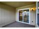 This is a view of the carpeted patio with a sliding glass door to the interior at 1632 Queensbridge Sq # 7, Indianapolis, IN 46219