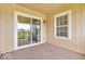 Relaxing outdoor patio featuring a sliding glass door, window, and exterior siding at 1632 Queensbridge Sq # 7, Indianapolis, IN 46219