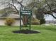 A lush green sign reads 'Wellington Green Condominiums', nestled among mature trees at 1632 Queensbridge Sq # 7, Indianapolis, IN 46219