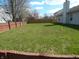 Large backyard featuring a well-maintained lawn and a wood privacy fence at 1643 Kayla Dr, Indianapolis, IN 46234