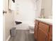 Bathroom features shower-tub combo and oak vanity with decorative fixtures at 1643 Kayla Dr, Indianapolis, IN 46234