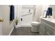 Well-lit bathroom features a walk-in shower with gray tile flooring and modern fixtures at 1643 Kayla Dr, Indianapolis, IN 46234