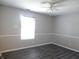 Bright bedroom featuring a ceiling fan, natural light from the window and wood-look floors at 1643 Kayla Dr, Indianapolis, IN 46234