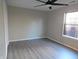 Bedroom featuring a ceiling fan, natural light from the window and wood-look floors at 1643 Kayla Dr, Indianapolis, IN 46234