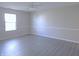 Neutral-toned bedroom with wood flooring and a bright window for natural light at 1643 Kayla Dr, Indianapolis, IN 46234