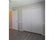 Bedroom features wood-look floors and ample storage with a wide closet at 1643 Kayla Dr, Indianapolis, IN 46234