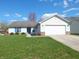 Charming single-story home with a well-maintained lawn and attached two-car garage at 1643 Kayla Dr, Indianapolis, IN 46234