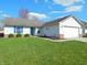 Charming single-story home with a well-manicured lawn, a two-car garage, and blue shutters at 1643 Kayla Dr, Indianapolis, IN 46234