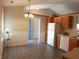 Bright eat-in kitchen area featuring wooden cabinetry and a view to an adjacent blue door and open space at 1643 Kayla Dr, Indianapolis, IN 46234