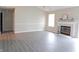 Bright living room showcasing a fireplace, wood flooring, and a large window providing natural light at 1643 Kayla Dr, Indianapolis, IN 46234