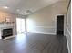Open living room featuring wood flooring, a fireplace, and a sliding glass door to the backyard at 1643 Kayla Dr, Indianapolis, IN 46234