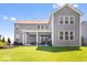 Expansive backyard featuring a covered patio, outdoor kitchen, and lush green lawn, ideal for outdoor living at 16688 Bowesmont Dr, Fortville, IN 46040
