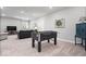 Spacious finished basement with a foosball table, a black sofa, and cozy seating at 16688 Bowesmont Dr, Fortville, IN 46040