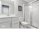 Modern bathroom features white cabinets, quartz countertop, and shower with glass door and white tile at 16688 Bowesmont Dr, Fortville, IN 46040