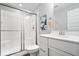 This bathroom includes a shower with sliding glass doors and a modern vanity with granite countertop at 16688 Bowesmont Dr, Fortville, IN 46040
