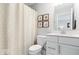 Modern bathroom with a white vanity, patterned shower curtain, and neutral decor at 16688 Bowesmont Dr, Fortville, IN 46040