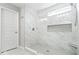 Elegant bathroom with a glass walk-in shower featuring marble walls and a small window at 16688 Bowesmont Dr, Fortville, IN 46040