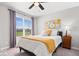 Cozy bedroom featuring a comfortable bed, grey walls, window, and pops of yellow to add some flair at 16688 Bowesmont Dr, Fortville, IN 46040