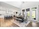 Bright dining area with hardwood floors, modern lighting, and open floor plan to the kitchen and living room at 16688 Bowesmont Dr, Fortville, IN 46040