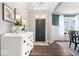 Bright entryway with wood floors, white dresser, and neutral walls leading into a dining area at 16688 Bowesmont Dr, Fortville, IN 46040